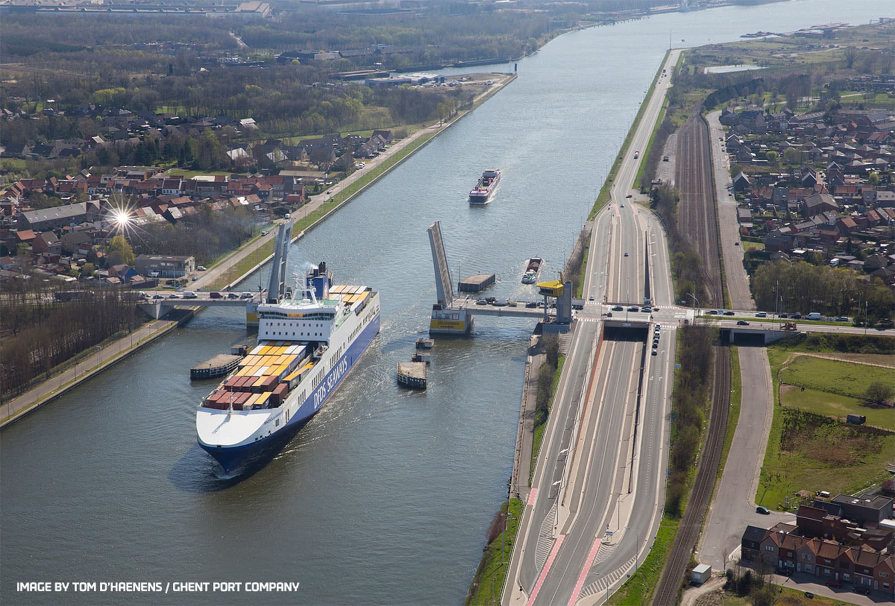 DFDS vessel passing through a drawbridge over the Ghent Canal