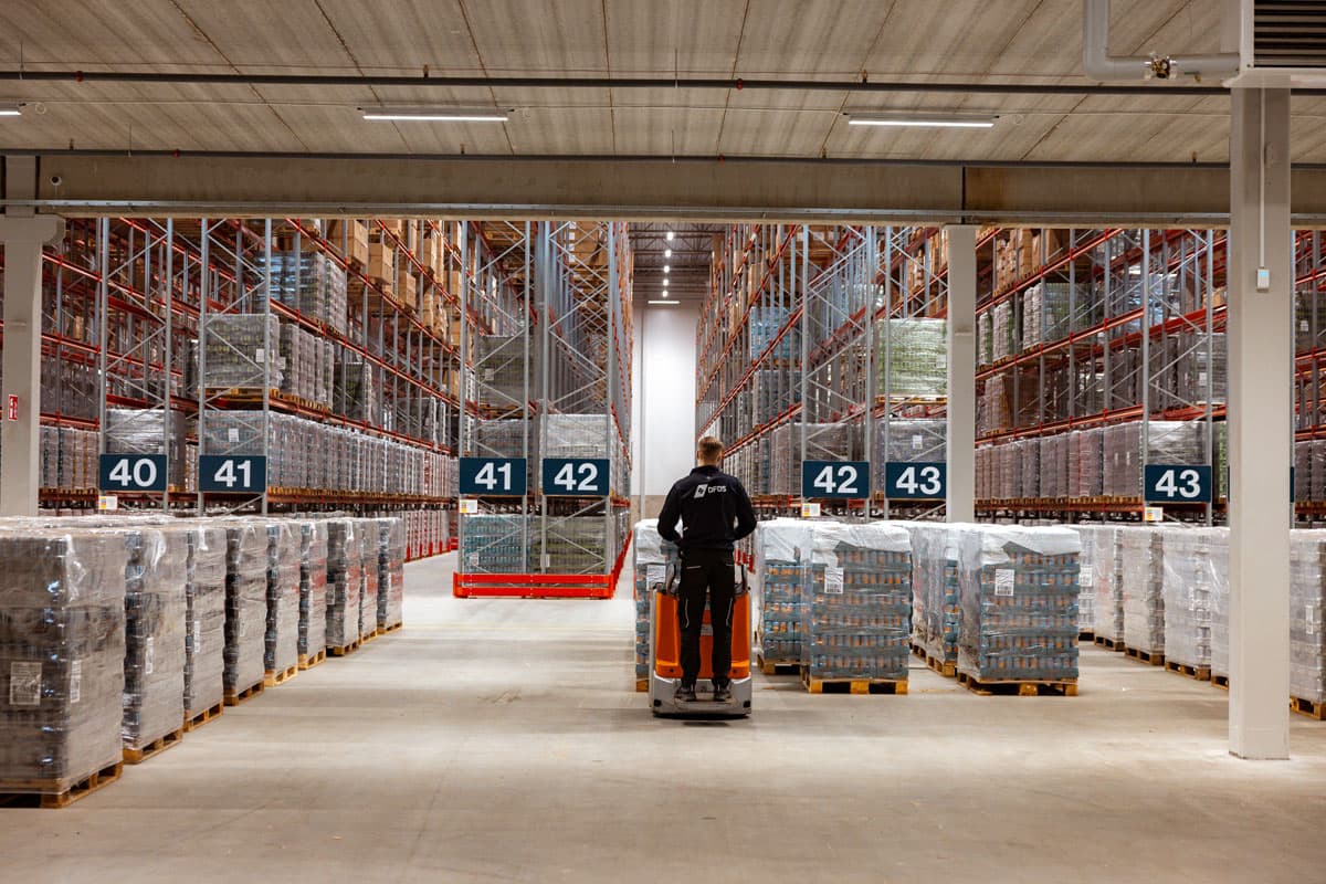 DFDS worker moving a pallet within a warehouse.