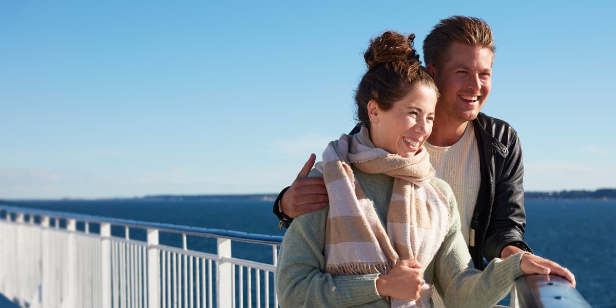 couple on deck watching the horizon