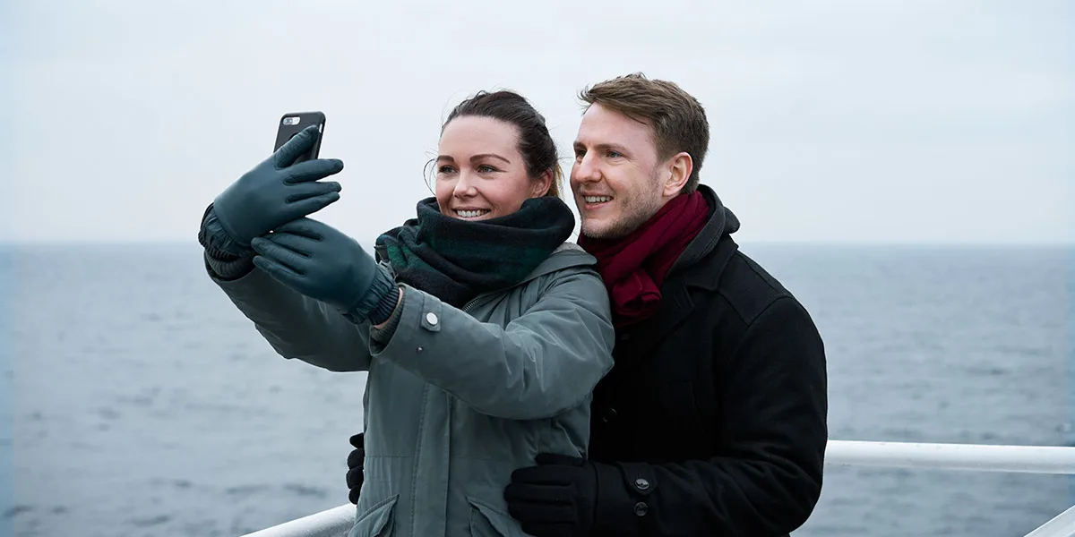 Couple on deck onboard DFDS ferry taking a selfie