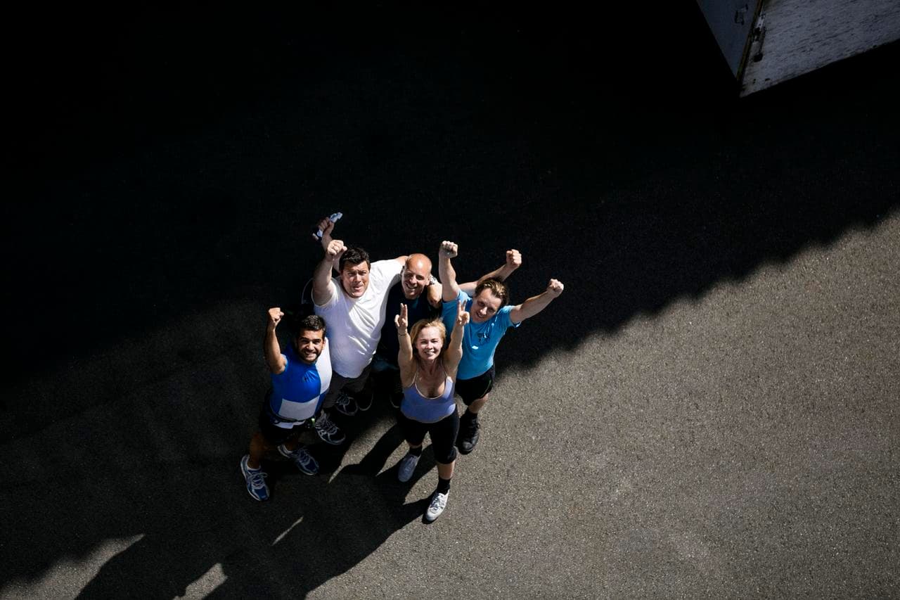 A group of DFDS employees raising their hands in joy after a sport event