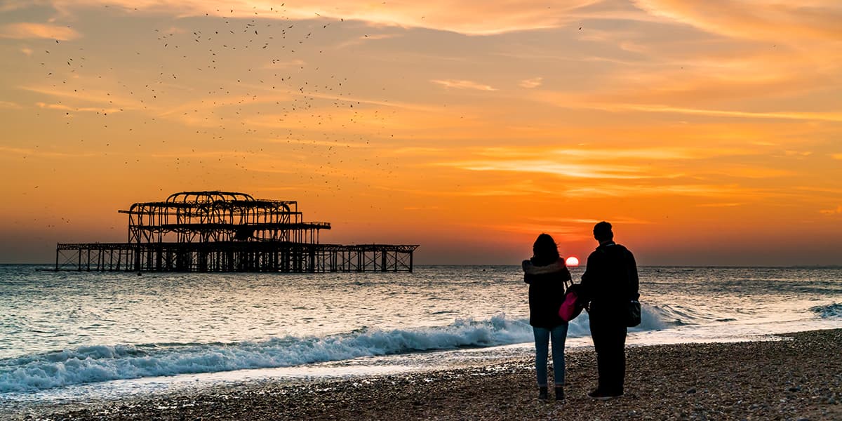 Couple looking at the sunset in Brighton