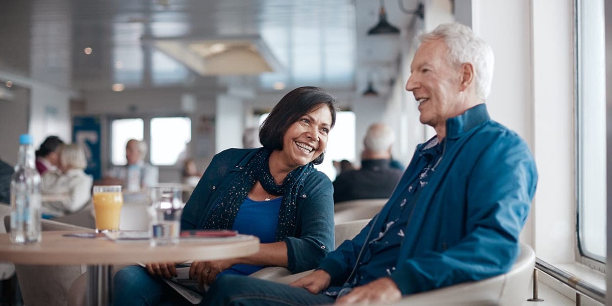 Elder couple enjoying themselves in Lighthouse Cafe onboard Eastern Channel Ferry.