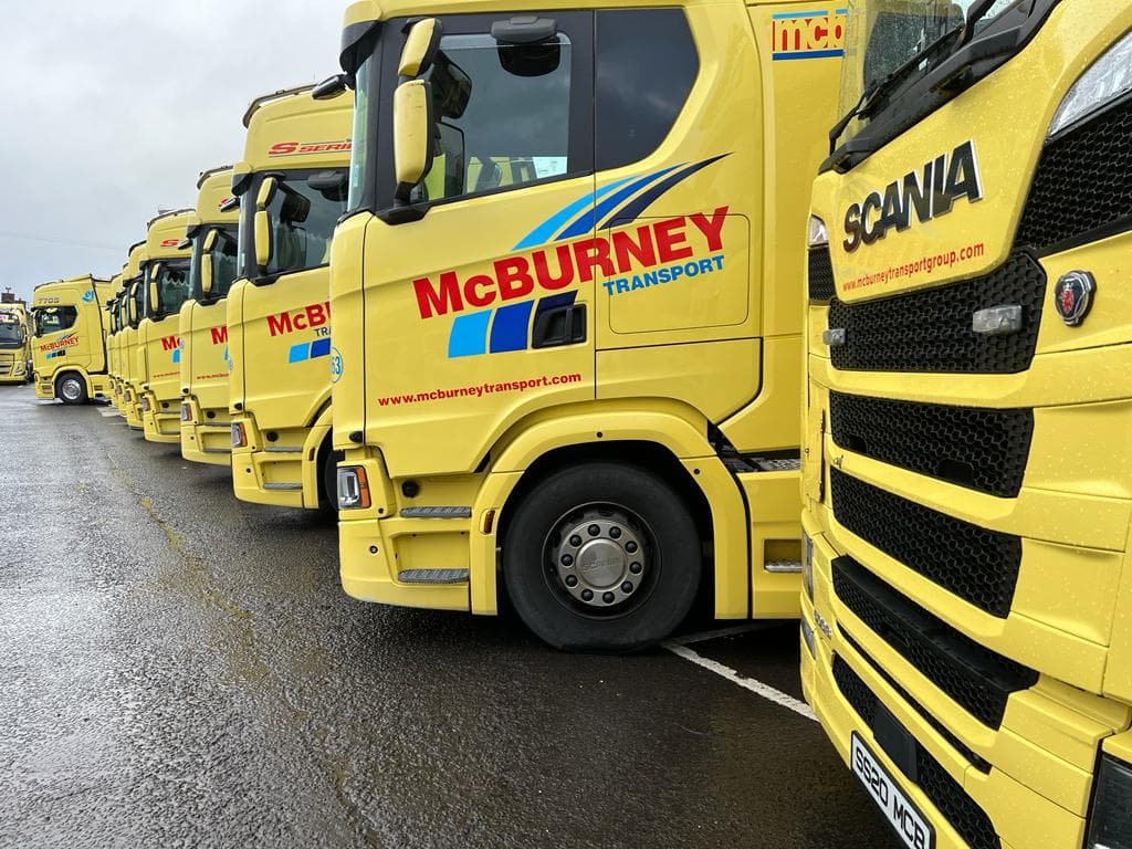 A row of yellow McBurney trucks